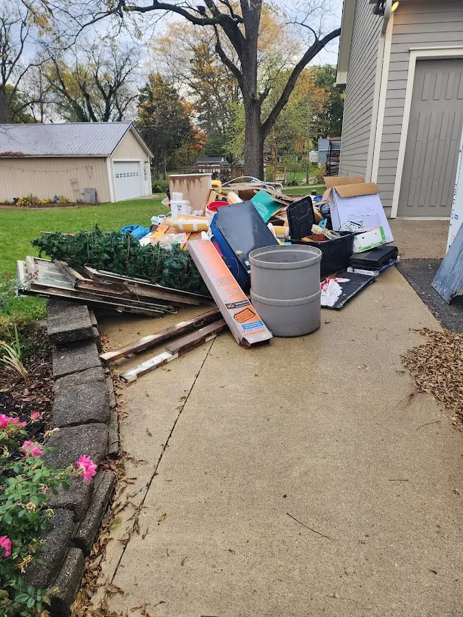 Dumpster being loaded with debris for Roofing Dumpster Rental in Morrilton